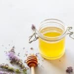 A glass jar of honey lavender syrup