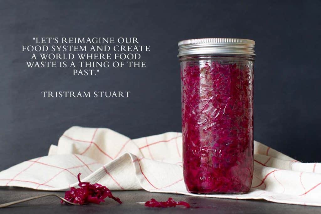 A jar of red sauerkraut on a linen tea towel.