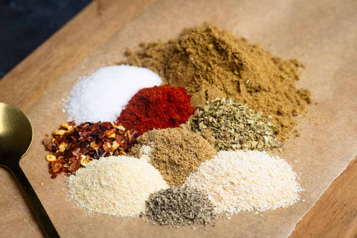 A pile of homemade burrito seasoning on a wooden board.