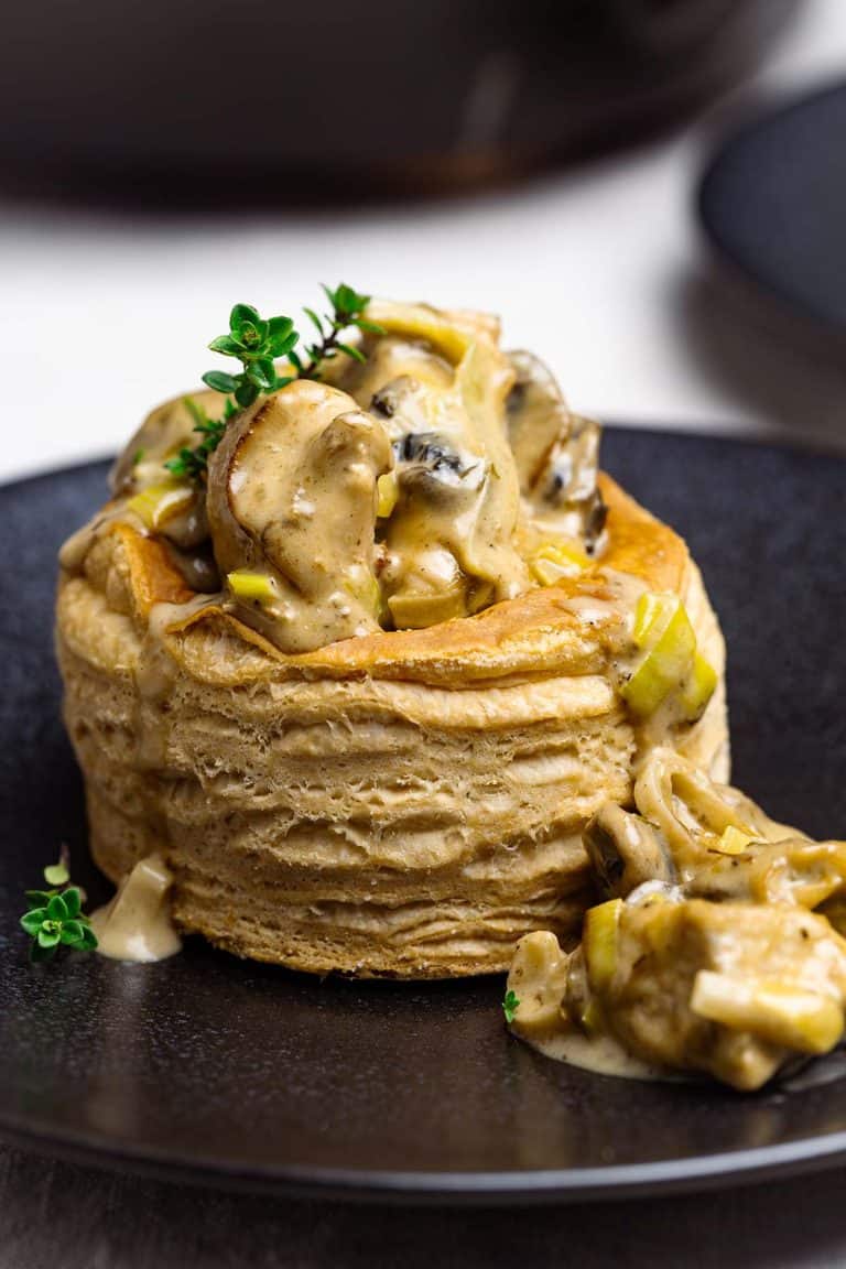 Mini chicken pot pies on a black plate.