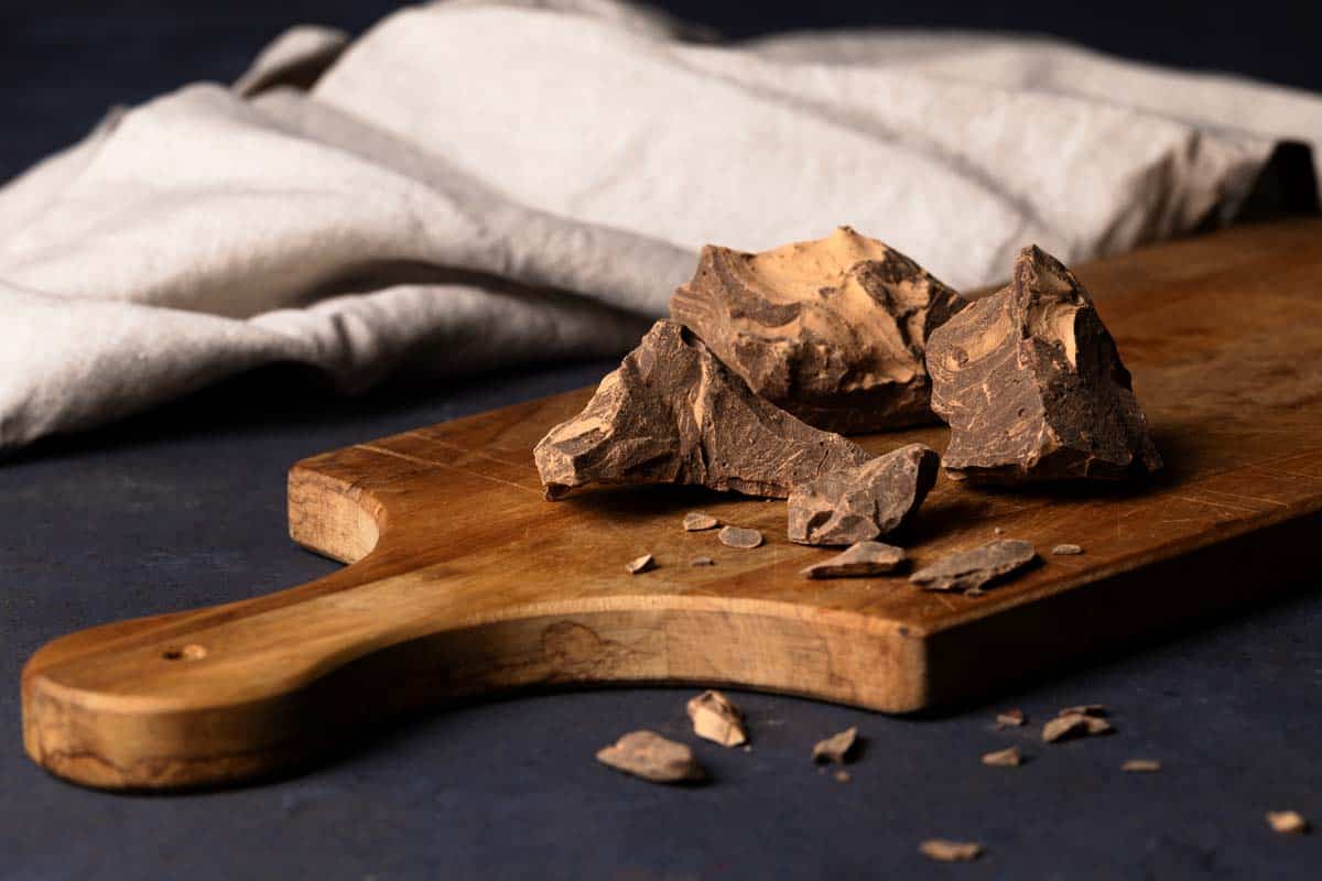 Raw cacao paste on a wooden board.