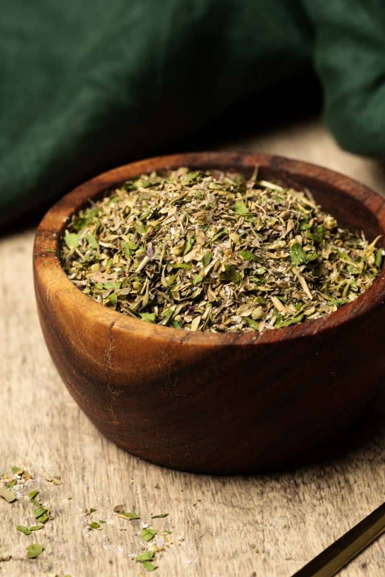 A wooden bowl filled with mediterranean seasoning.