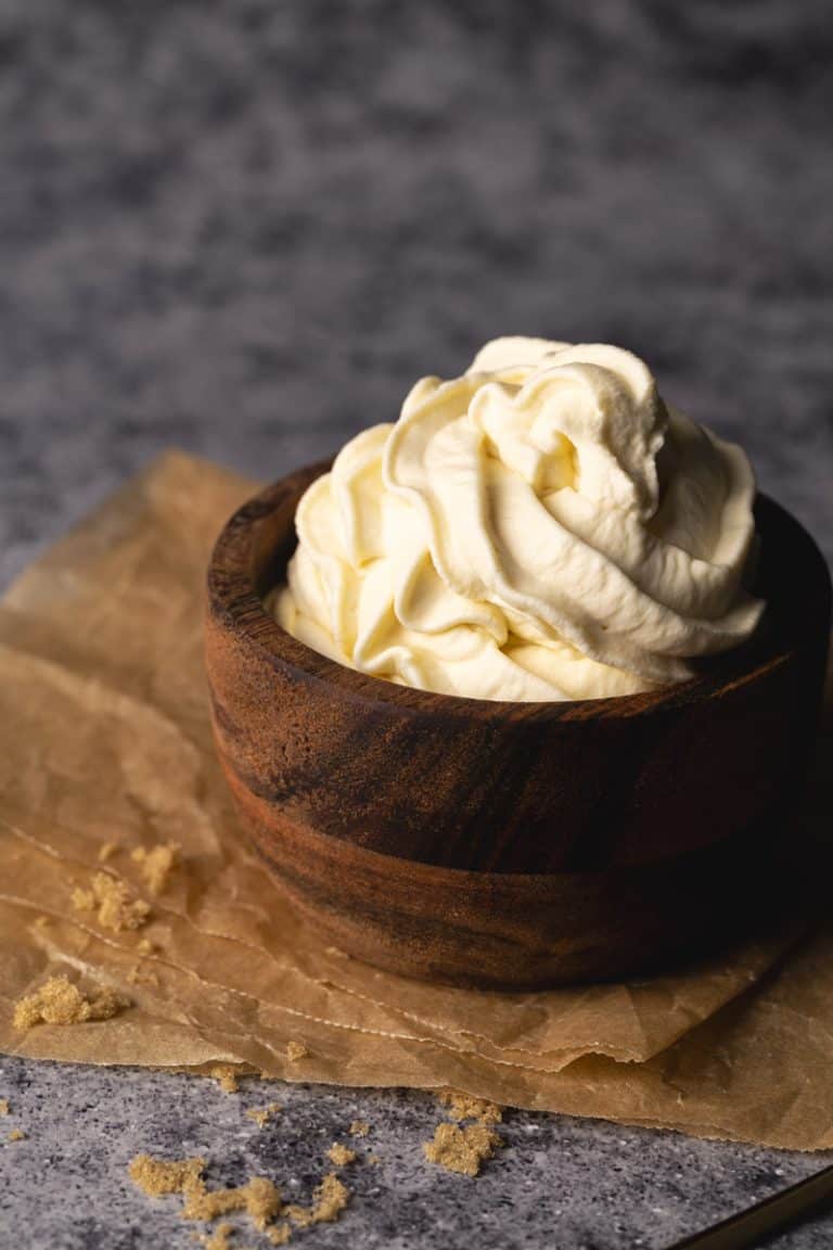 A wooden bowl filled with brown sugar whipped cream.