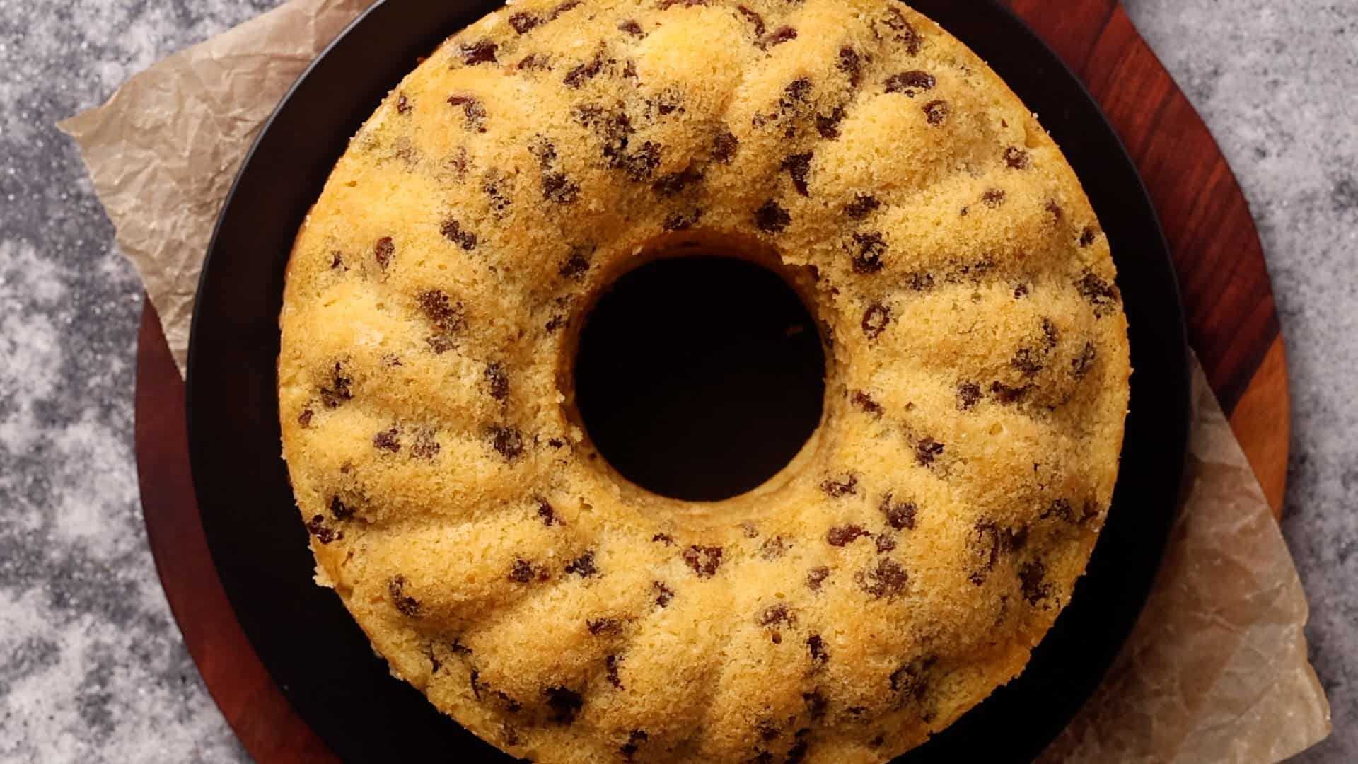 A raisin cake on a black plate.