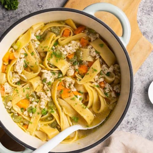 Chicken soup with noodles in a large Dutch oven.