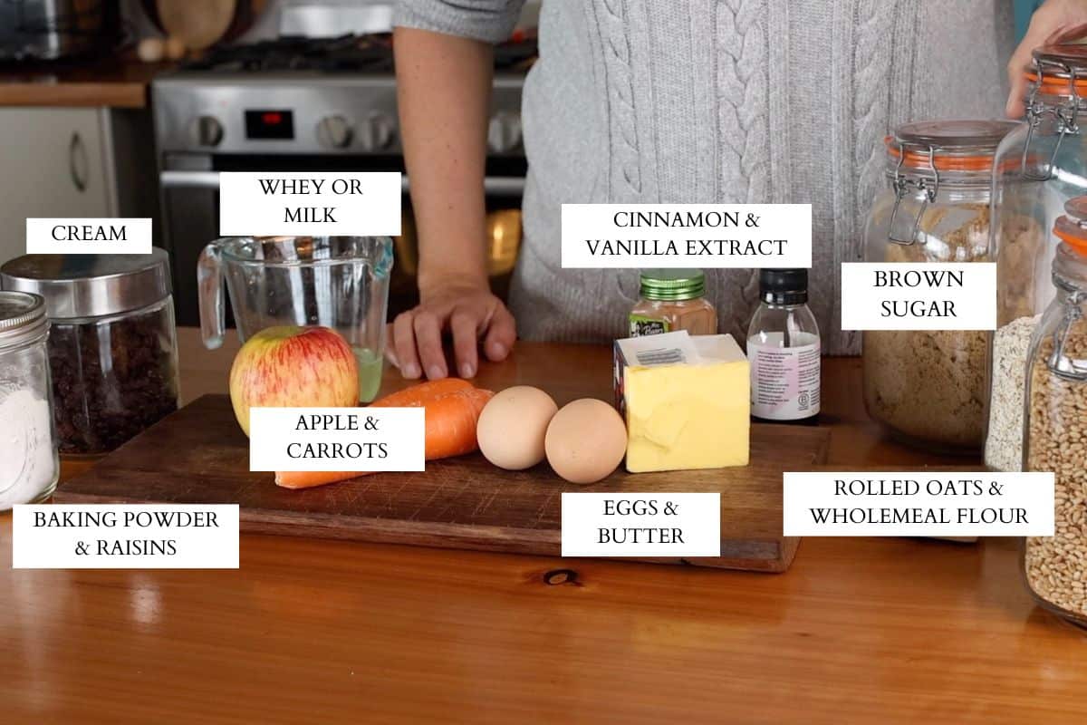 Ingredients for apple and carrot muffins laid out on a wooden kitchen bench.