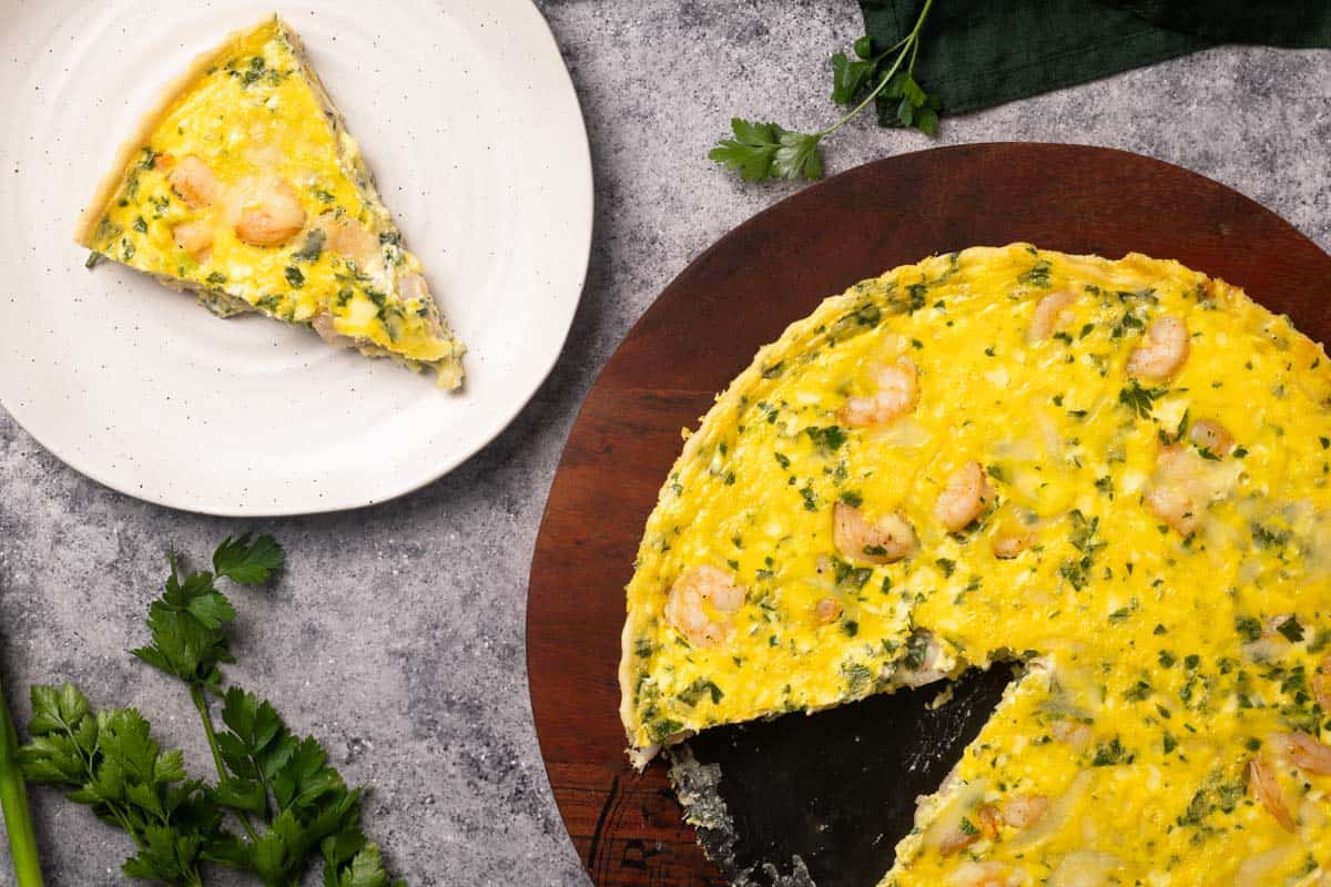 Shrimp quiche on a wooden board.