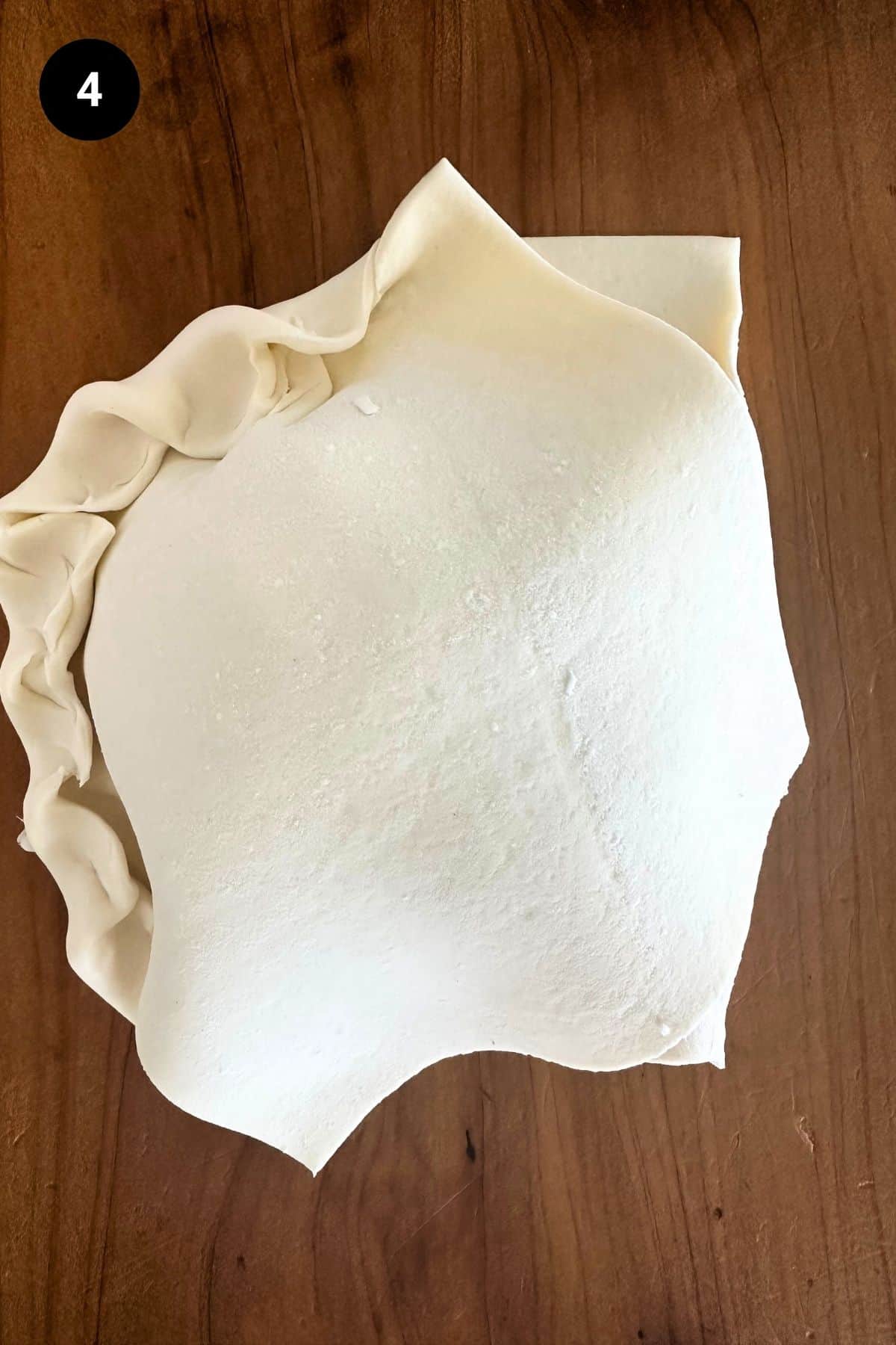 Pastry being folded on a single serve lamb wellington.