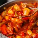 Italian goulash being scooped out of a large pan.