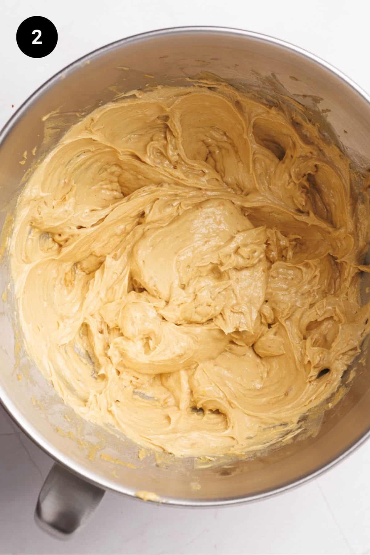 Wet ingredients well combined in a metal bowl.