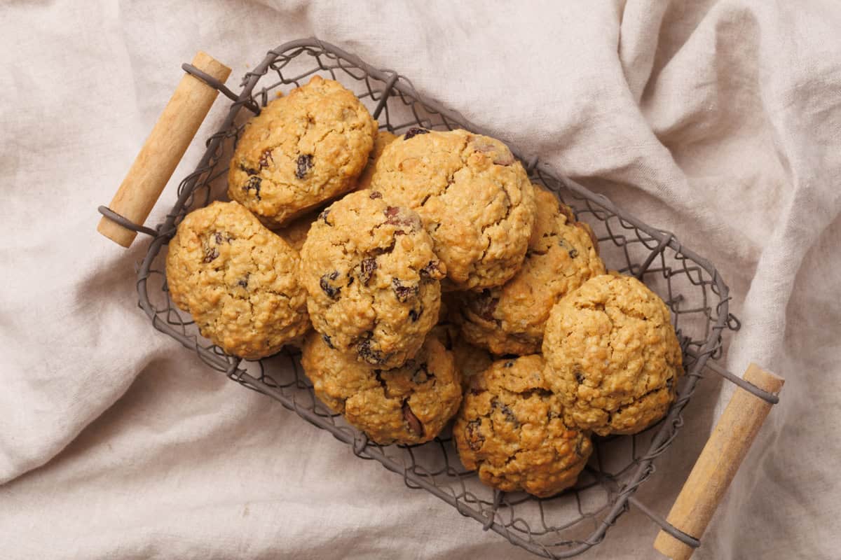 A wire basket filled with energy cookies on a linen cloth.