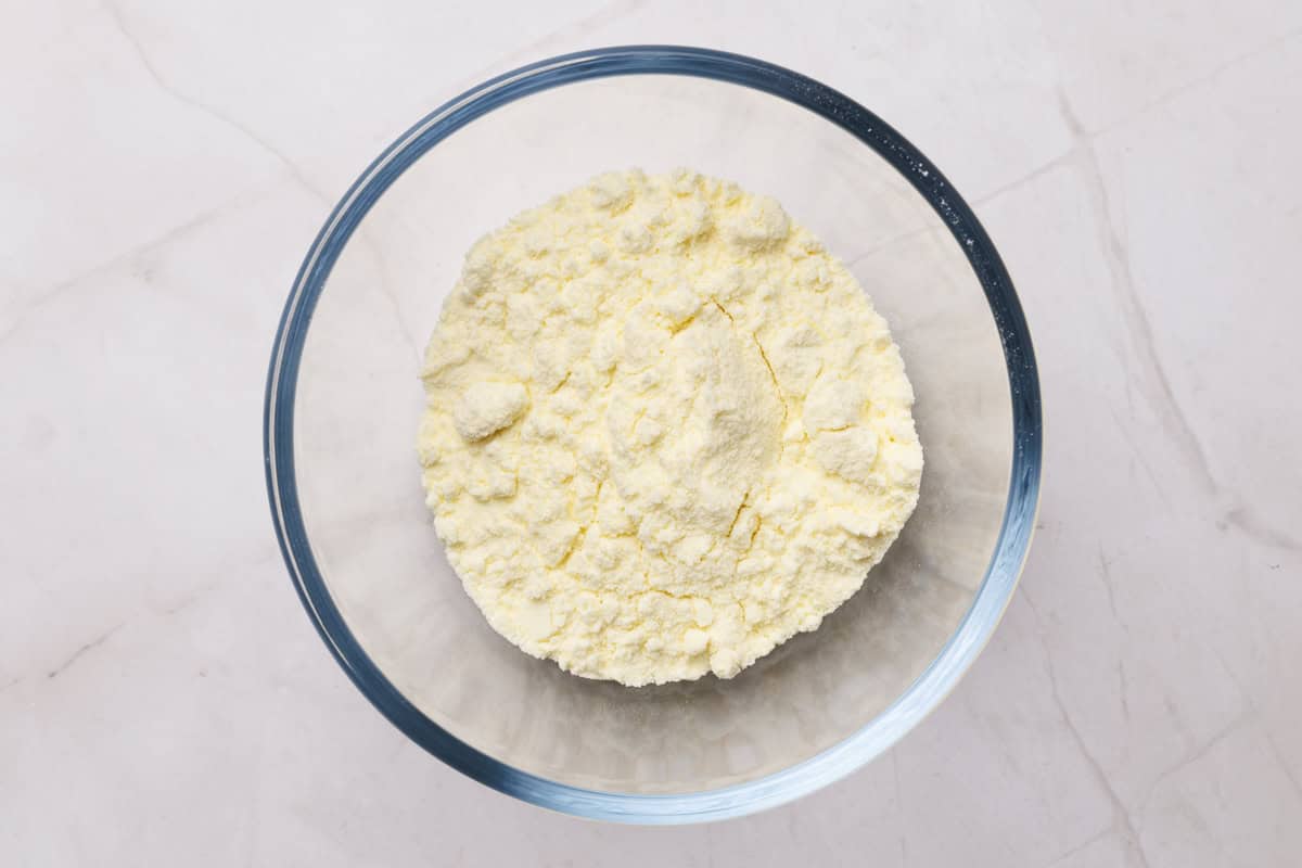 Milk powder in a glass bowl.