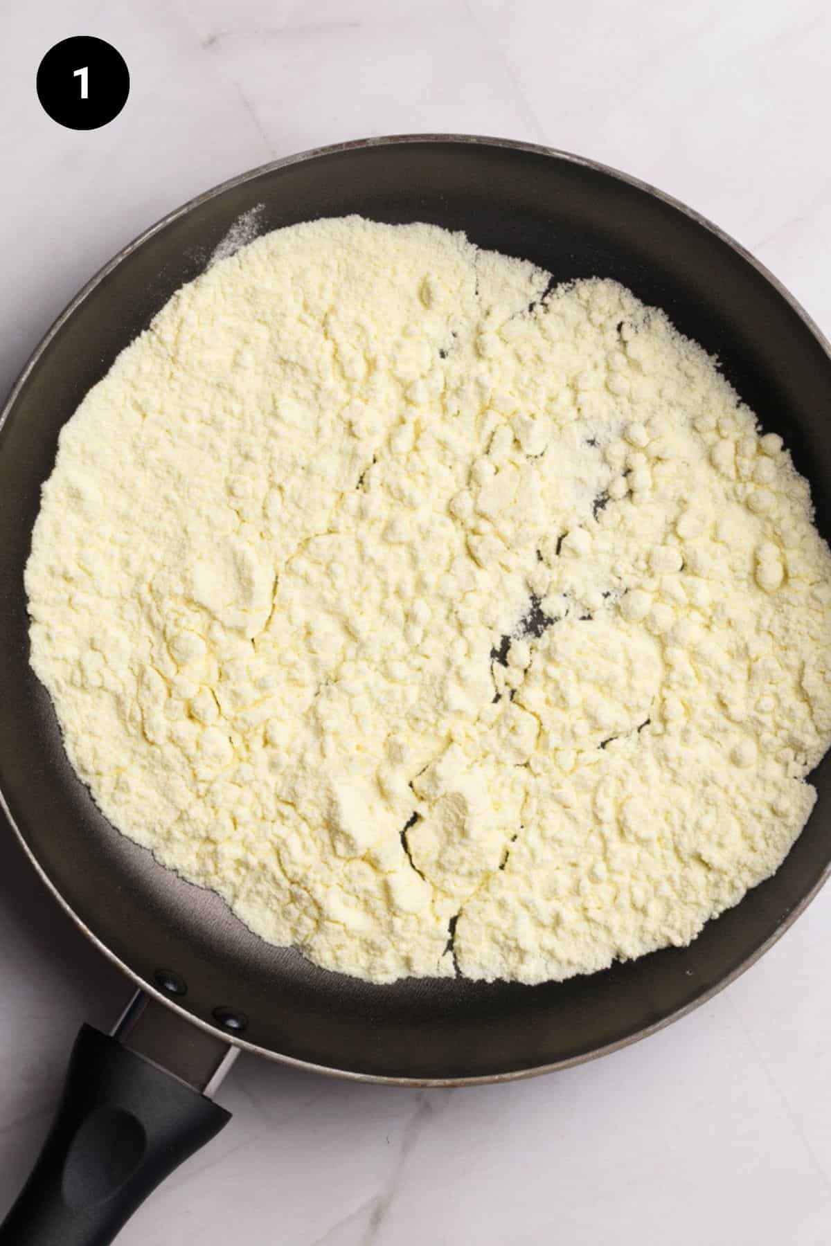 Milk powder in a black pan.