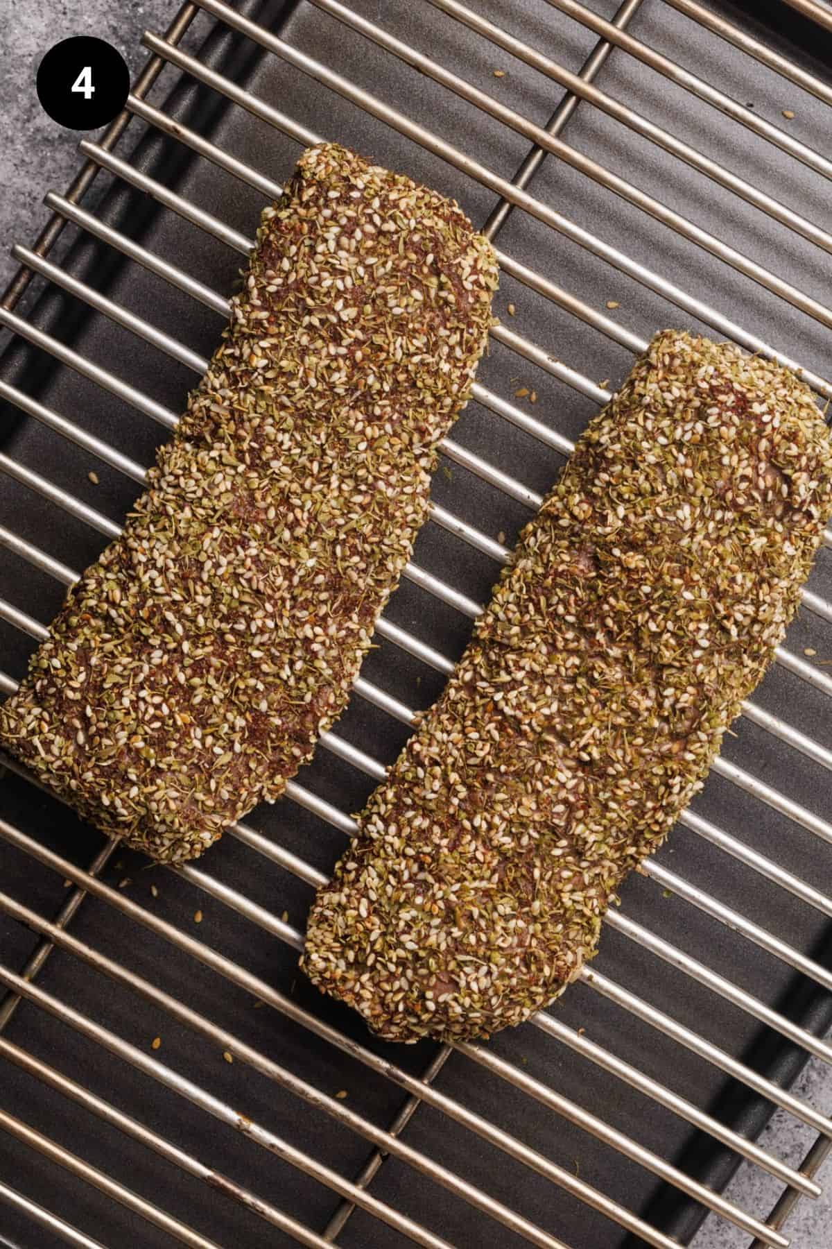 Crusted lamb loins on a rack.