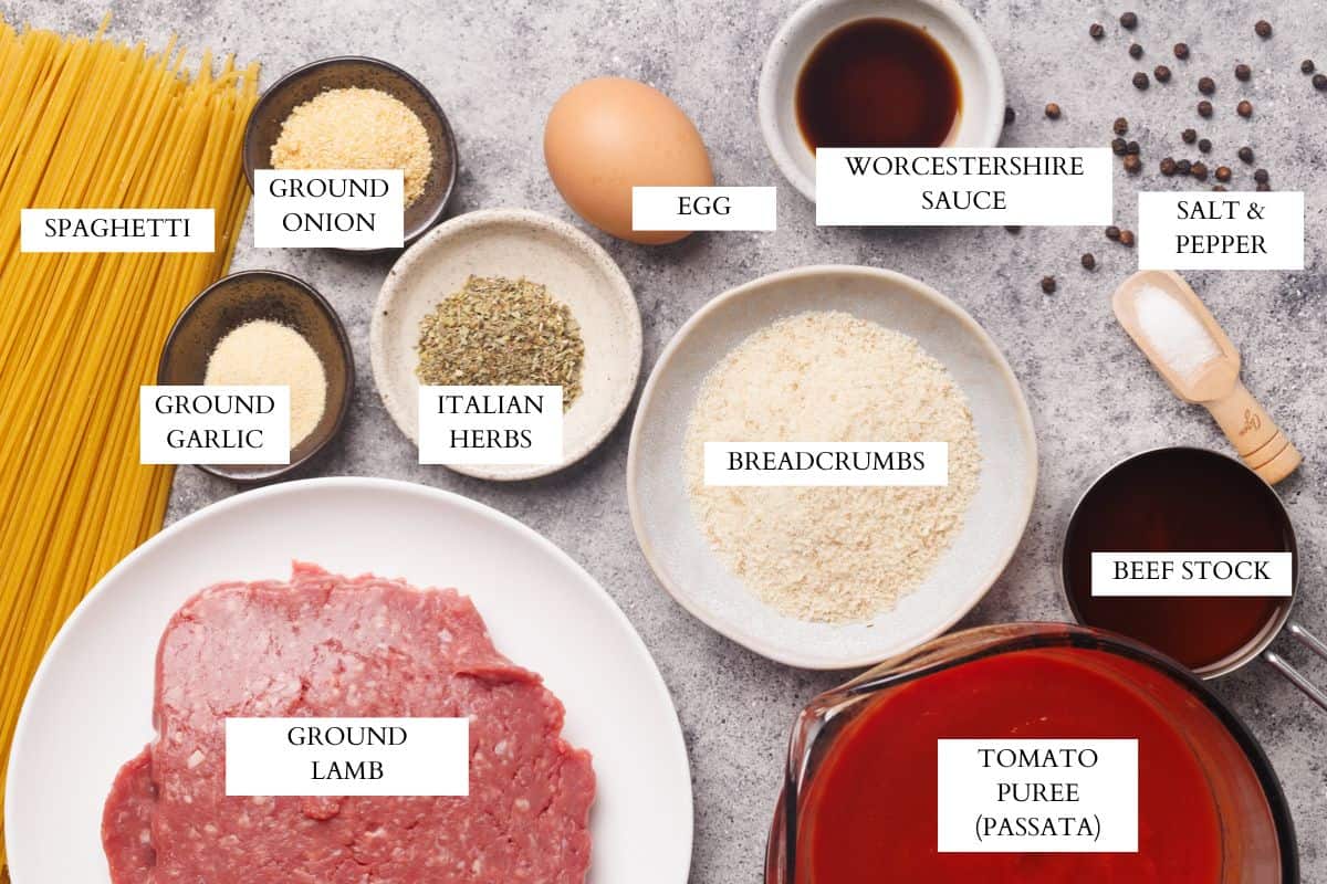 Ingredients laid out to make spaghetti casserole with meatballs.