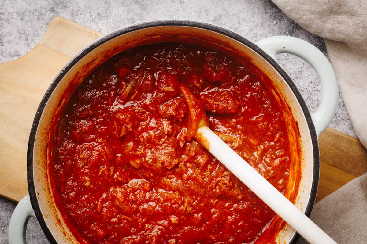 Lamb ragu sauce in a Dutch oven.