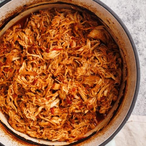 Pulled chicken in a Dutch oven.