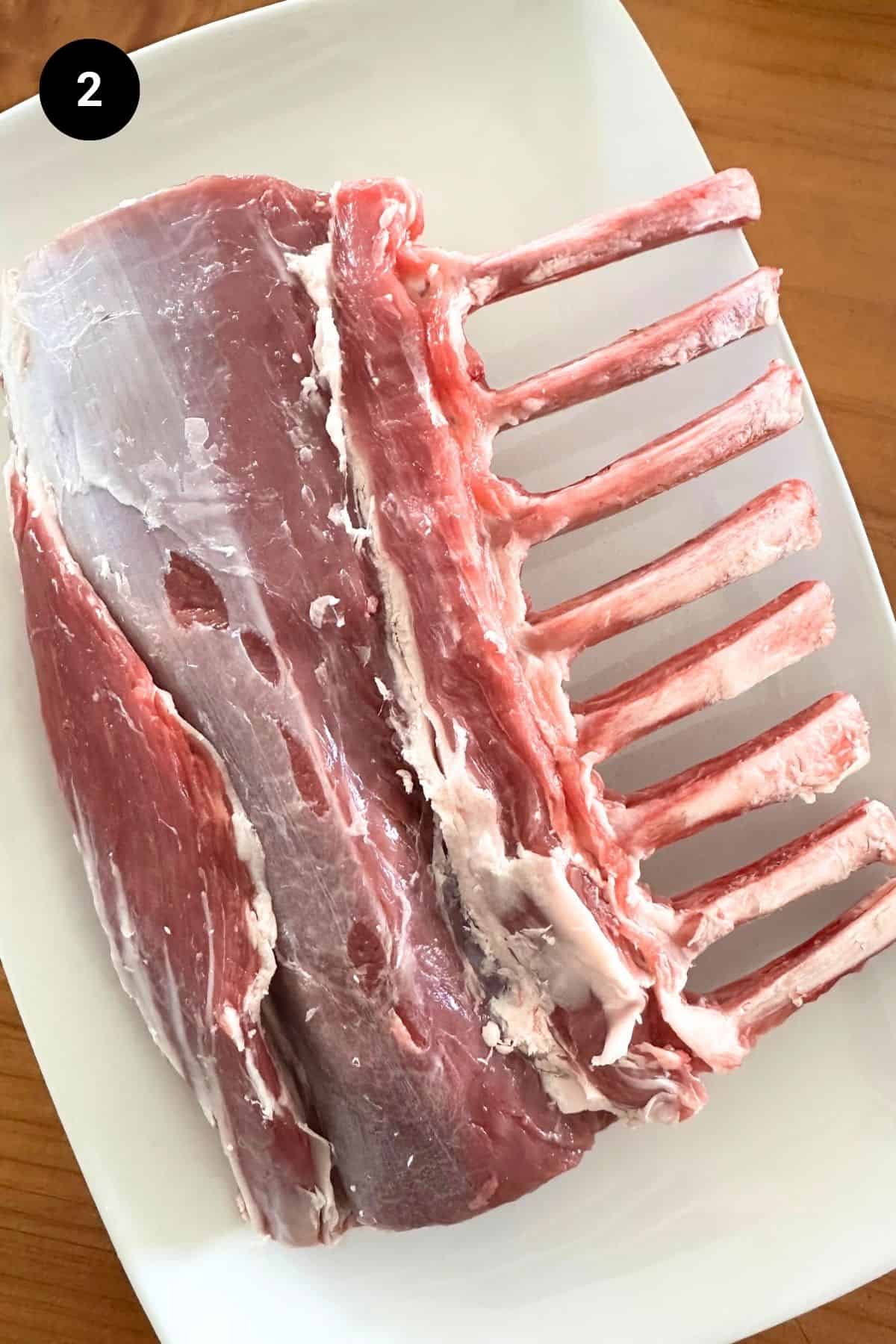Lamb rack with fat removed ready to be cut into cutlets.