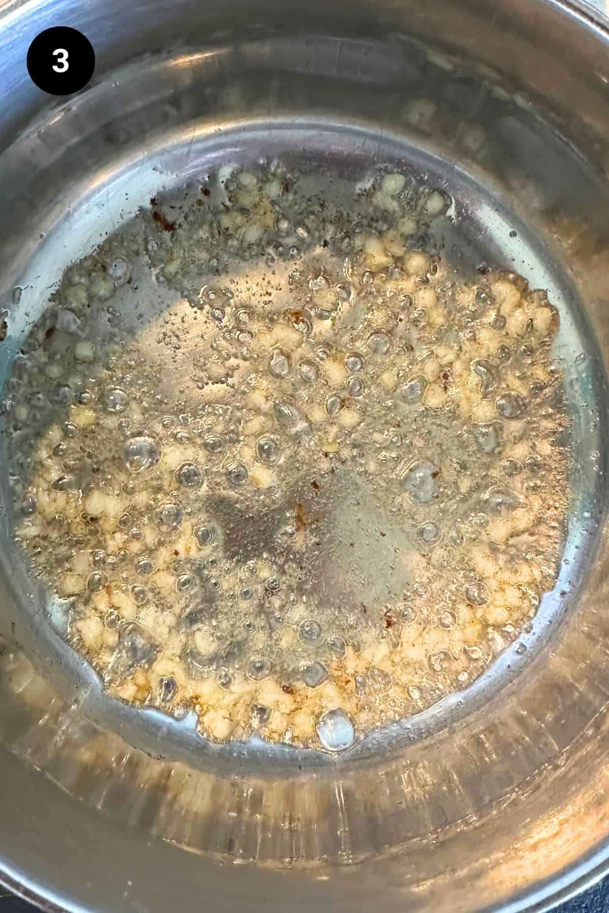 Garlic being cooked in lamb fat.