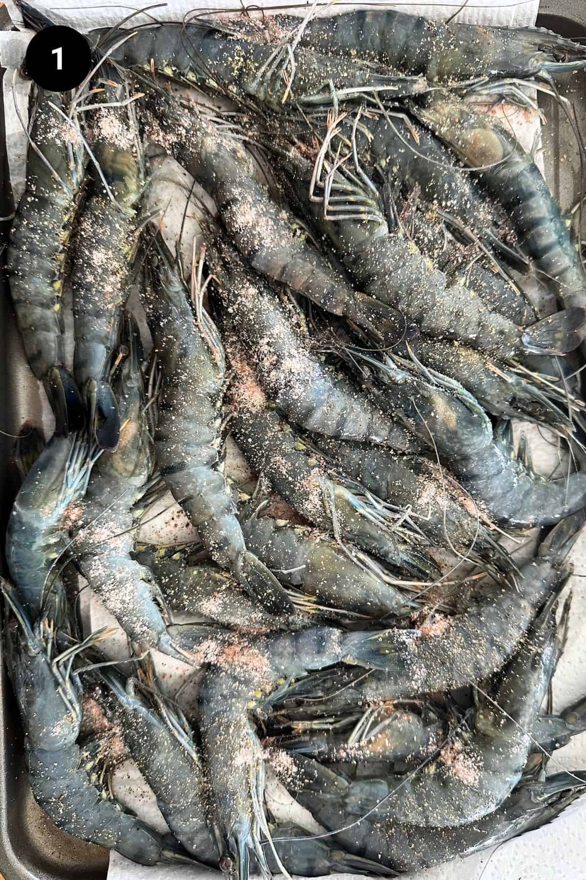 Black tiger shrimp seasoned on a tray.