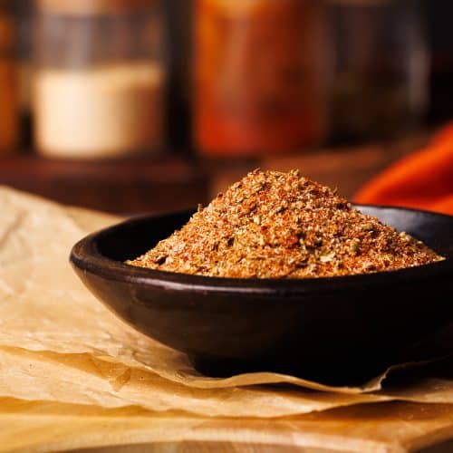 Homemade taco seasoning in a small wooden bowl.