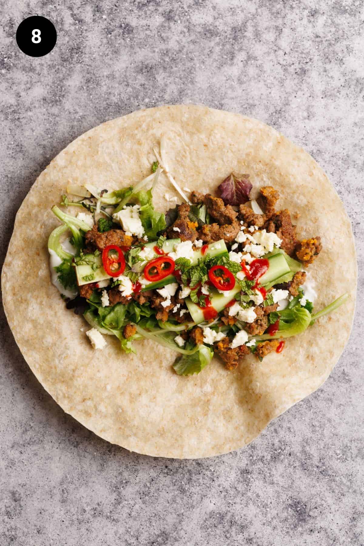 Lamb wrap fillings on a tortilla ready to wrapped.