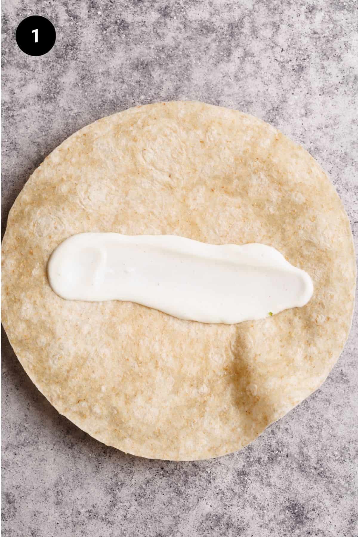 Lemon yogurt sauce added to a flour tortilla.