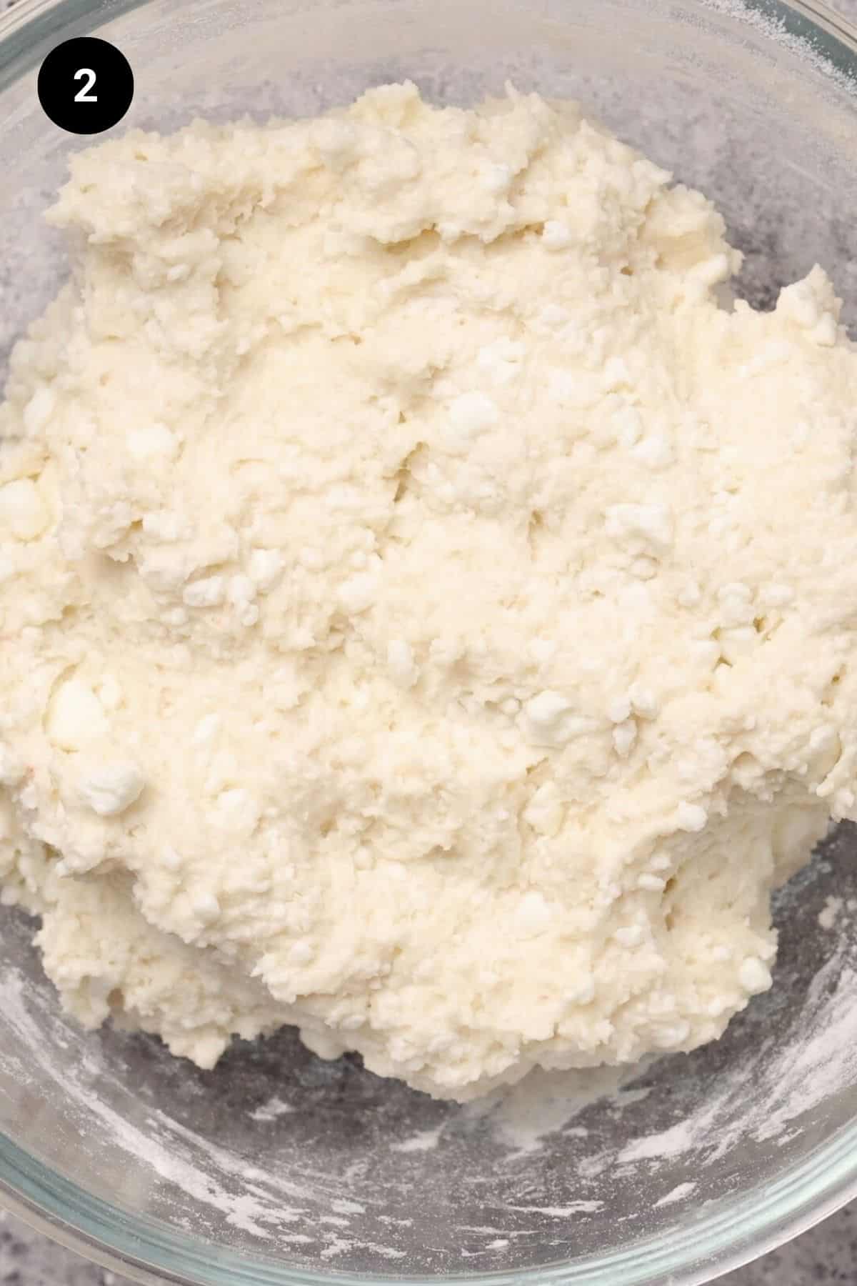 Kneaded dough in a glass bowl.