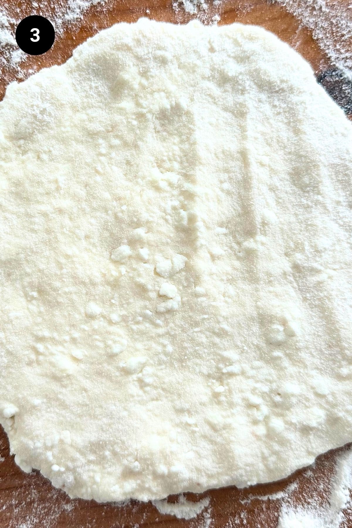 Shaped flatbread on a floured bench.