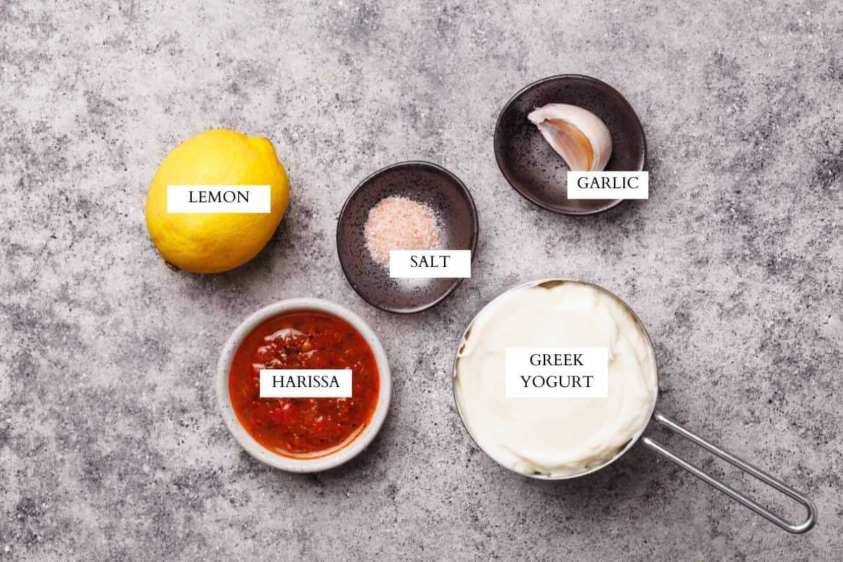 Ingredients laid out to make a harissa yogurt sauce.