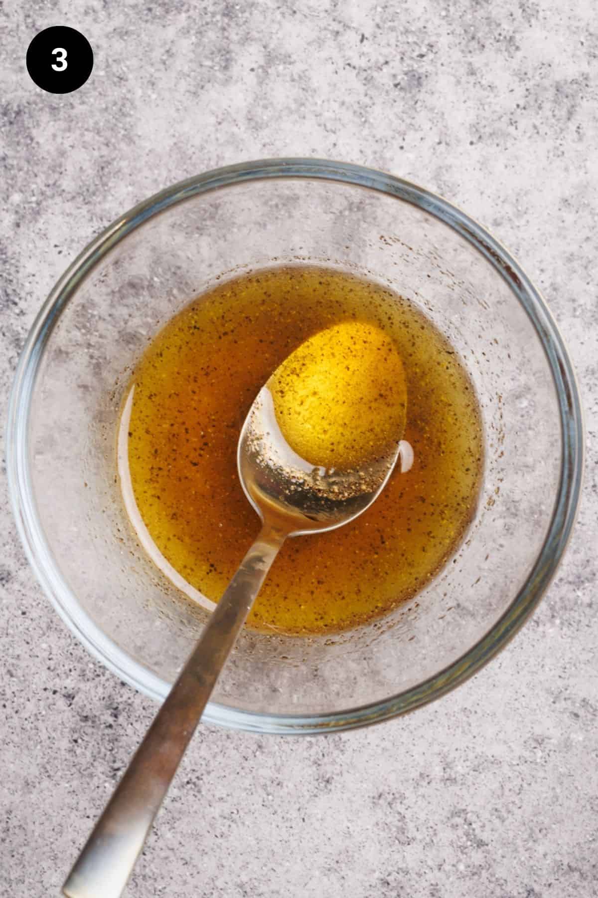 Vinaigrette ingredients in a small bowl before being mixed.