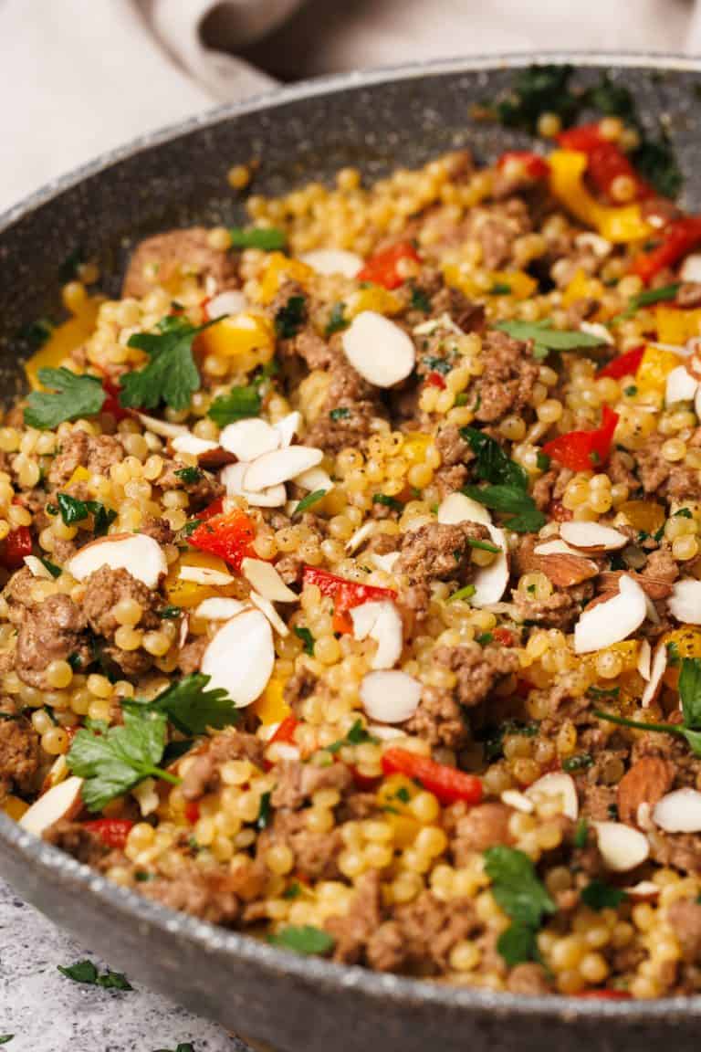 Lamb couscous in a grey pan.