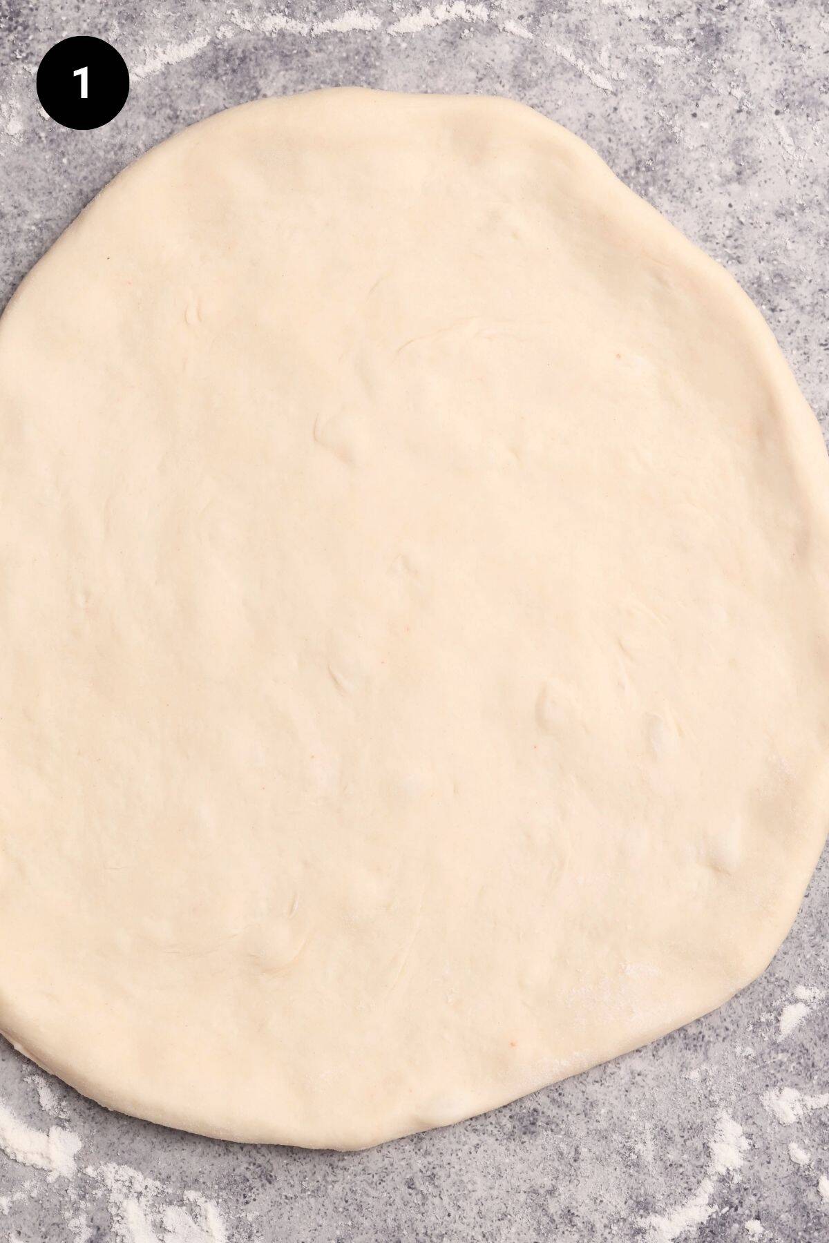 Pizza dough shaped ready for the toppings to be added.