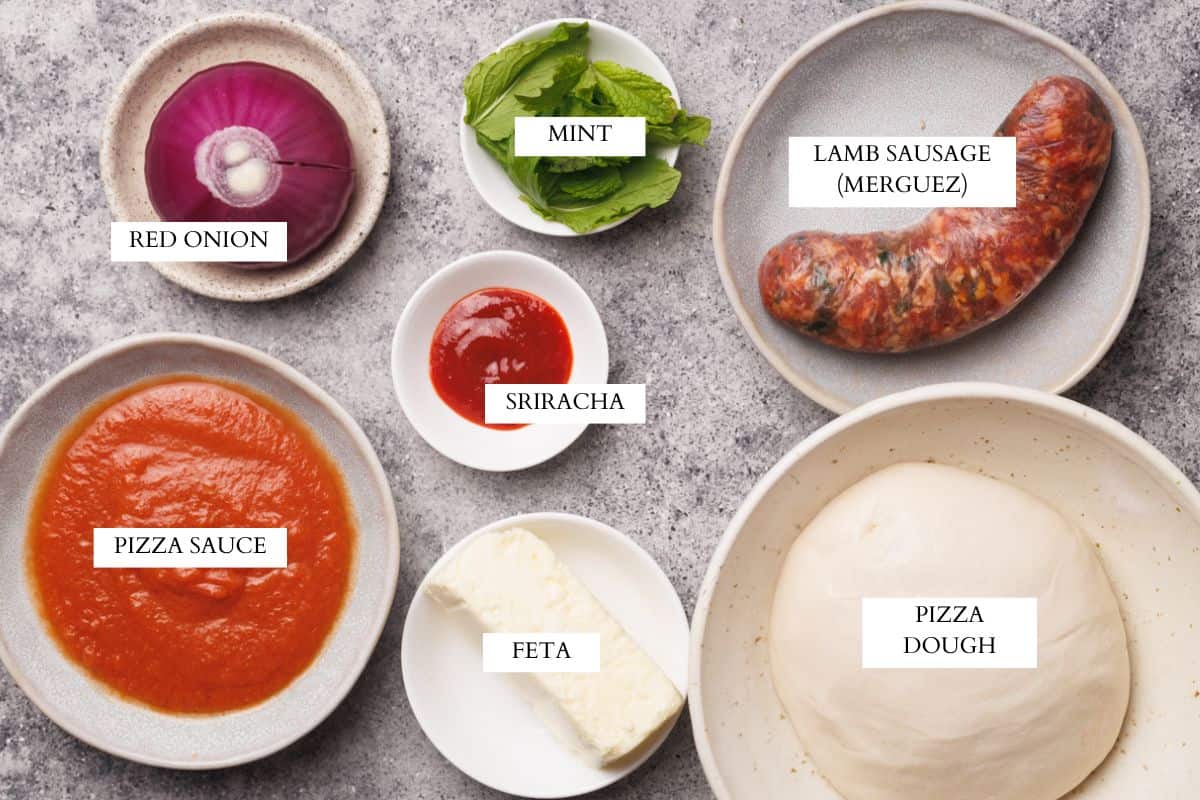 Ingredients laid out to make lamb sausage pizza.