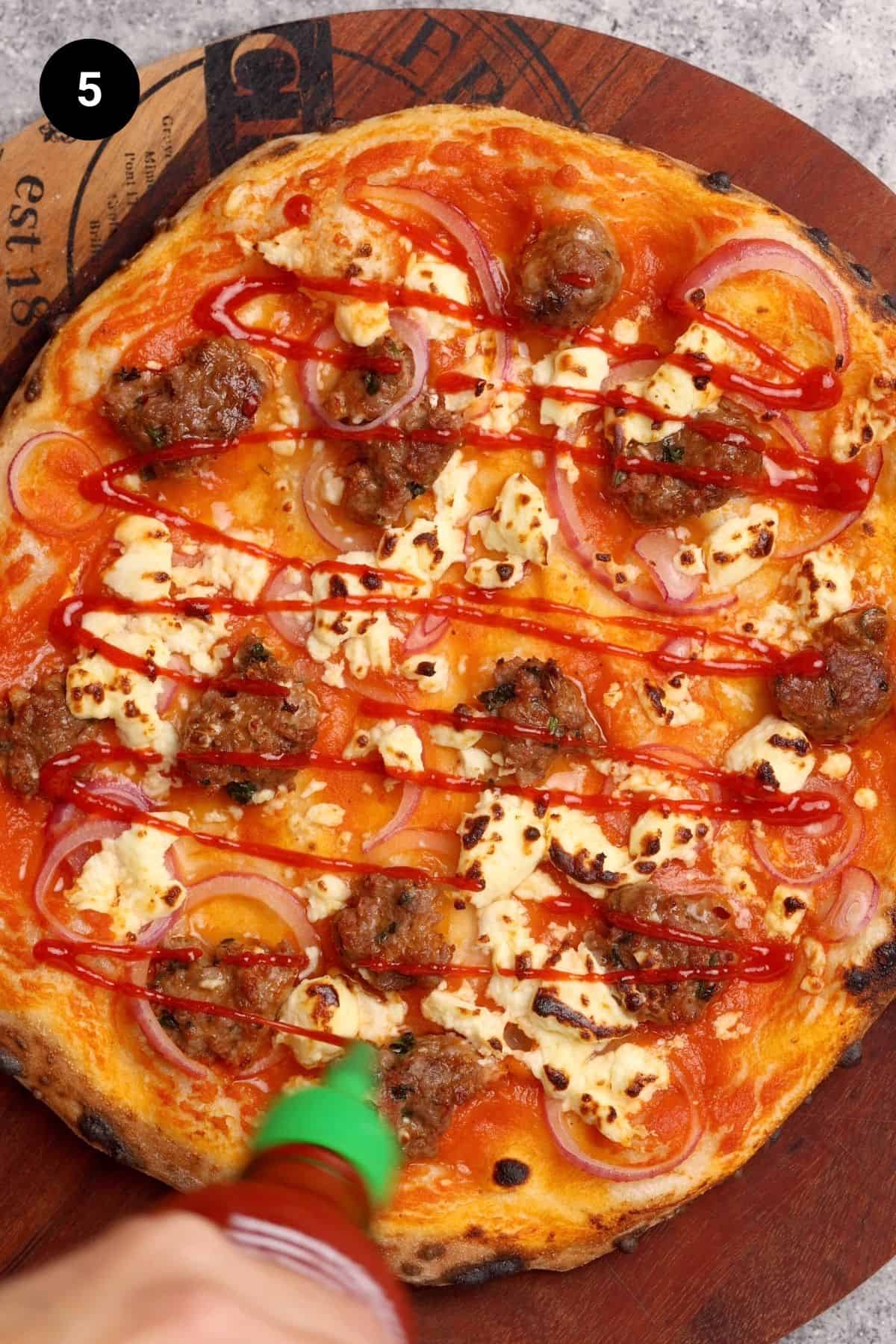 Sauce being added after the pizza has been baked.