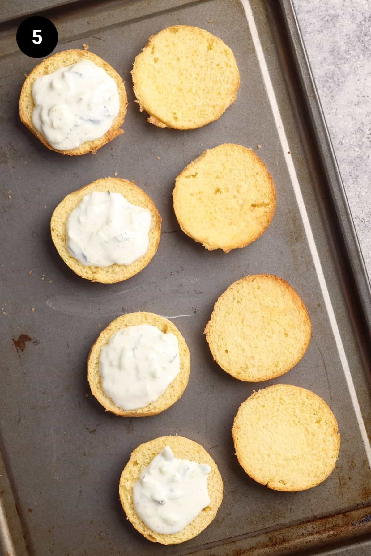 Lamb sliders being assembled on a baking tray.