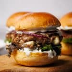 A lamb slider on a wooden board.