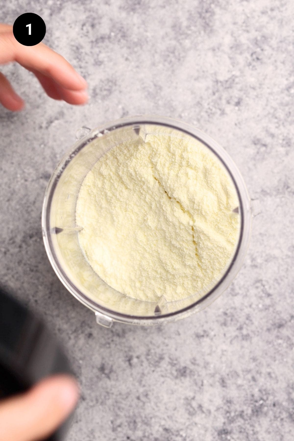 Milk powder and milk in a blender before being blended.