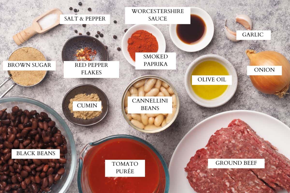 Ingredients laid out to make baked beans with ground beef.