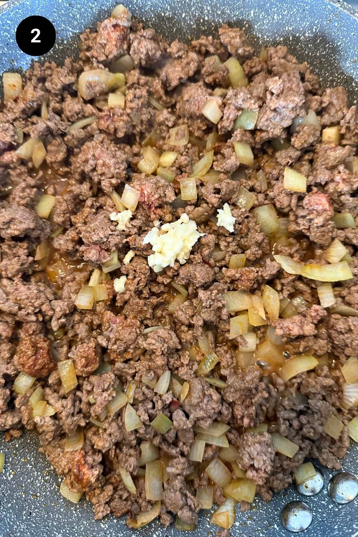 Browned beef in a pan.