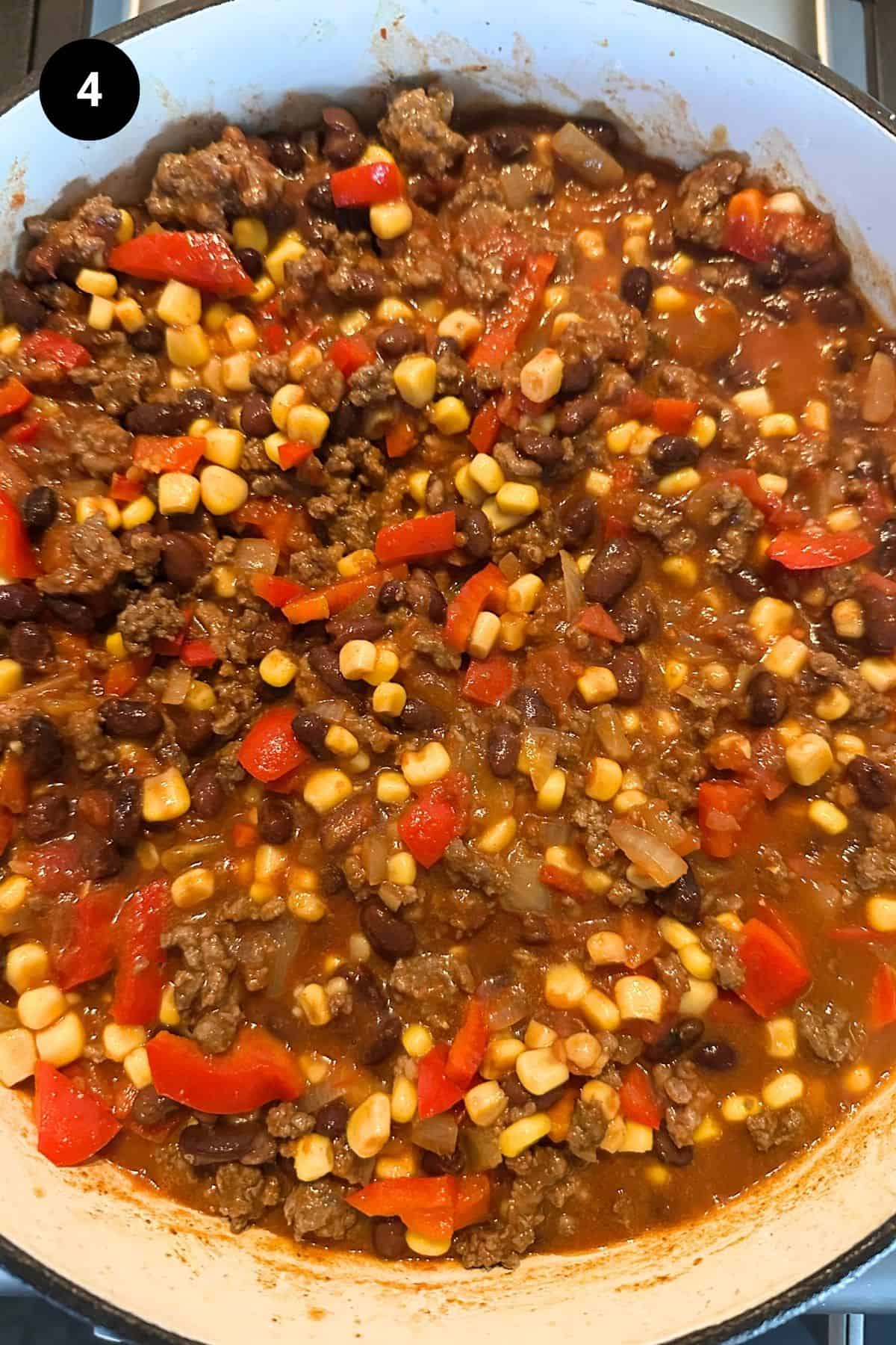 Ground beef and veggie mixture in a Dutch oven.